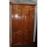 An early 19th century pine standing corner cupboard with fluter pilaster supports and having raised,