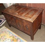 A 19th century carved oak four panel coffer, 117cm by 55cm by 74cm