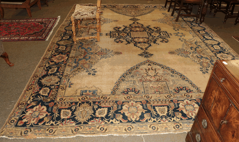 Tabriz carpet, the mustard field with indigo central medallion framed by wide indigo borders 400cm