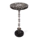 a Steampunk Industrial metal tripod table, constructed using various industrial sprockets, gears,