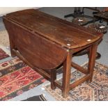 An 18th century and later oak drop leaf table, 137cm diameter