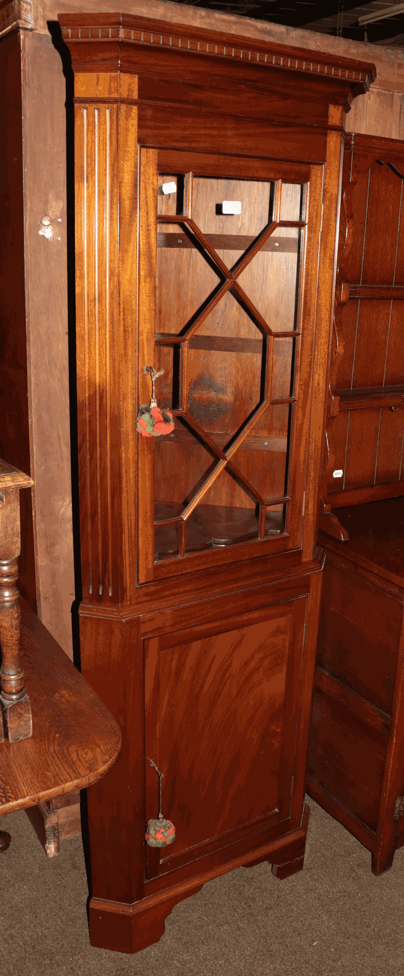 A reproduction mahogany standing corner cabinet with astragal glazed top section, 184cm