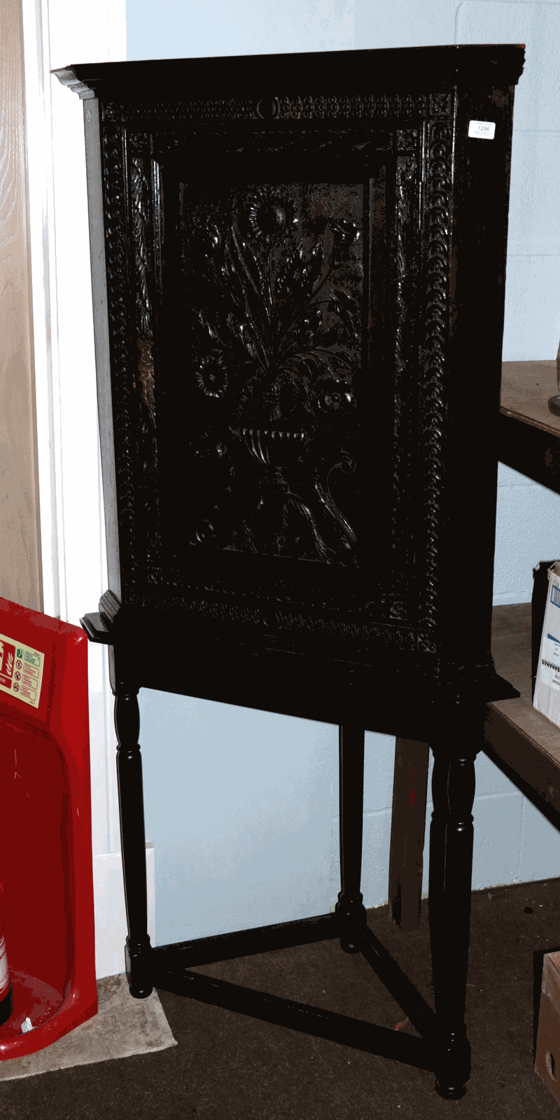 A Georgian carved oak corner cupboard on an associated later corner table, 75cm by 167cm