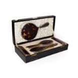 A cased five-piece silver and tortoiseshell mounted brush set