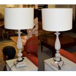 A modern pair of large wooden table lamps, as light grey distressed effect reeded balusters on