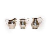 Two Victorian silver cream-jugs and a George V silver cream-jug, one by Susanna Cook, London,