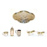 A tray of silver items including an Edwardian quatrefoil dressing tray embossed with cherubs, by