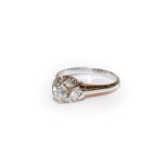A diamond solitaire ring, the round brilliant cut diamond in a white claw setting, to a tapered