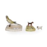 A 1920s cold painted metal model of a budgerigar on an alabaster dish and another similar of a