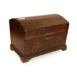 An 18th century oak dome top table box, the hinged lid enclosing a later candle box above two