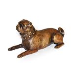 A reproduction patinated metal model of a recumbent pug with glass eyes