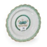 An 18th century Worcester lobed plate, decorated with gilt and French green enamel with a saw