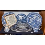 A quantity of blue and white pottery mainly in the Willow pattern, including early 19th century