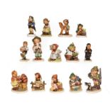 A tray of fourteen Hummel figures . Three figures damaged the remainder in generally good condition