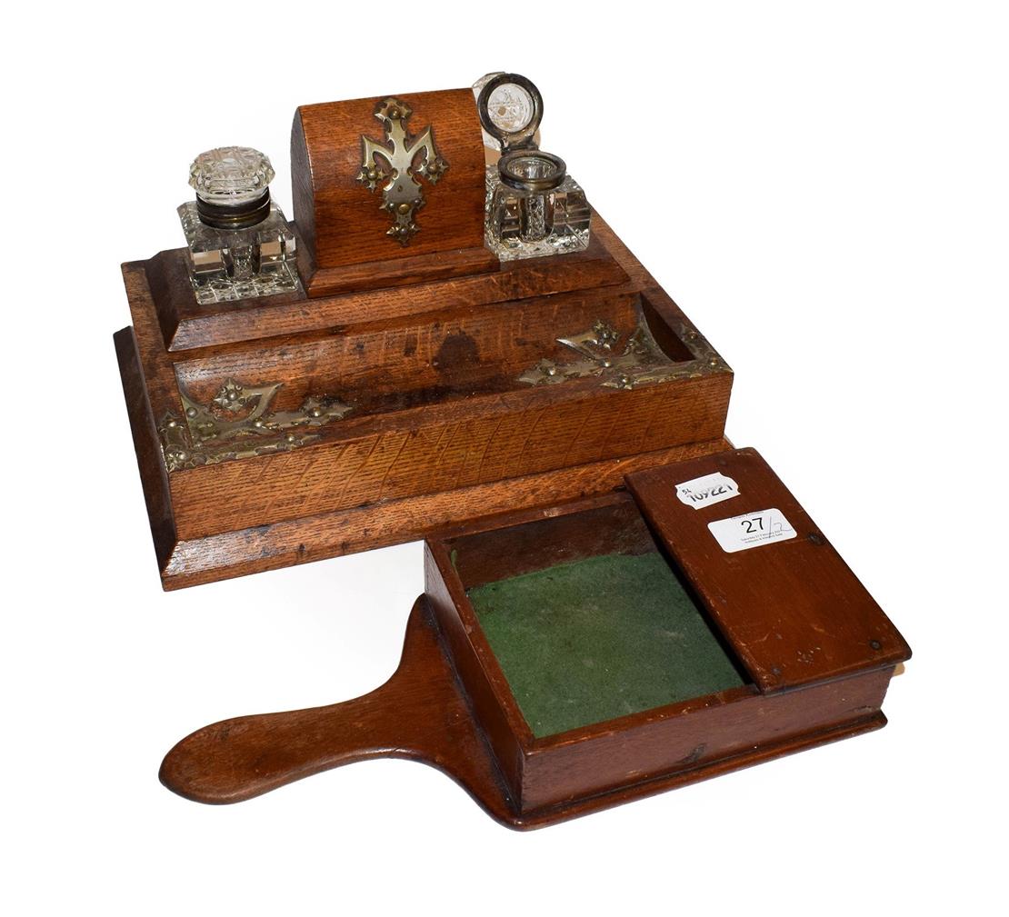 An Edwardian oak desk standish with a pair of cut glass inkwells, together with a mahogany offertery