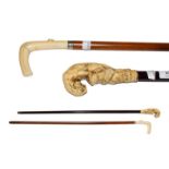 An ivory mounted walking stick, circa 1900, the handle carved as a tiger above an ibex, 89cm and a