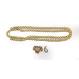 A cultured pearl necklace, clasp stamped '9CT', length 59cm; a 9 carat gold split pearl crown and