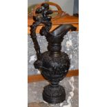 A 19th century bronze ewer in Renaissance style, decorated in high relief with bacchanalian putti,