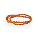 An amber bead necklace, length 65cm . Gross weight 38.0 grams.
