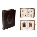 A Victorian tooled leather photograph album full with portraits