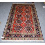 Yerevan rug of Lesghi design, the crimson field with columns of stars enclosed by floral borders,