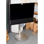 A Bang & Olufsen BeoVision television on motorised stand, with remote control, 26" screen