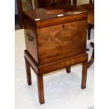 A George III mahogany cellarette on stand, inlaid, with bronze handles and raised on reeded square