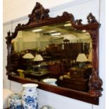 An imposing carved mahogany over-mantel mirror, with scroll work pediment, 206cm by 136cm high