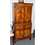 A reproduction mahogany veneered cocktail cabinet, 72cm by 37cm by 153cm high