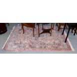 Kashmir silk piled rug, the candy field centred by a medallion enclosed by spandrels of meandering