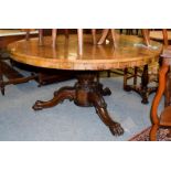 A Victorian mahogany breakfast table on reeded baluster column and carved paw feet, 133cm diameter