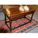 A joined oak refectory table, with plain frieze, on turned legs with block feet joined by a