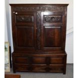 Period oak linen cabinet of pegged construction and raised on three drawer base, 148cm by 54cm by