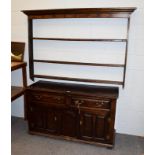 An 18th century oak dresser, 140cm by 50cm by 83cm high; together with a similar plate rack, 165cm