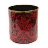 A Fornasetti Enamelled Tin Waste Paper Basket, with repeating classical foliate design in red,