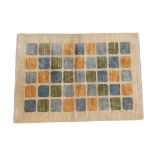 A 20th Century Wool Rug, with green, blue and orange rectangles on an oatmeal ground, labelled RC