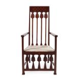 An Art Nouveau Mahogany Armchair, the top rail decorated with heart motifs, above carved