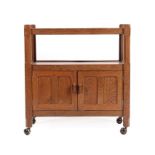 A Sid Pollard of Thirsk English Oak Tea Trolley, the two tiers above two panelled cupboard doors, on