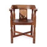 Robert Mouseman Thompson (1876-1955): An English Oak Monk's Chair, with curved back and shaped arms,