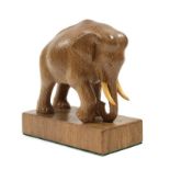 Woodpeckerman: Stan Dodds (1928-2012): An English Oak Elephant Carving, with right front leg raised,