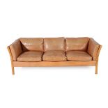 A 1970's Danish Tan Leather Three Seater Sofa, on an ash and canvas frame, 222cm wide, 85cm deep,