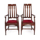 A Pair of Scottish Arts & Crafts Oak Dining Armchairs, with pierced top rail above three shaped