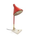 A 1960's Stilux Table Lamp, with a red shade on a lacquered brass and red adjustable arm, on a white