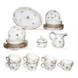 A quantity of Meissen porcelain tea wares painted with scattered sprigs and three similar tea