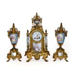 A gilt metal porcelain mounted striking mantel clock with garniture, circa 1890