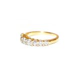 A diamond eight stone ring, the graduated round brilliant cut diamonds, in yellow claw settings,