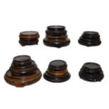 A quantity of Chinese carved hardwoood stands including 19th century examples (one tray)