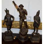 A pair of late 19th century French patinated spelter figures of warriors and another of a minor,