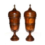 Theodore Alexander, a pair of modern turned hardwood urns and covers with patinated metal finial'
