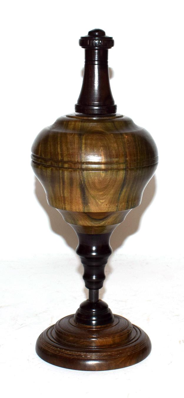 A lignum vitae and ebony plumb bob on stand, 29.5cm